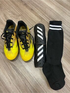 Kids Adidas soccer cleats, shin guards, and socks.